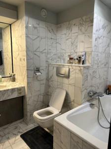a bathroom with a toilet and a sink and a tub at Studio à Monaco Fontvieille in Monte Carlo