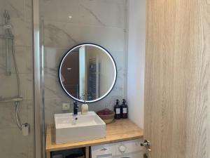 a bathroom with a sink and a mirror at Studio le Monroe les pieds dans l'eau 10 m de la mer in La Seyne-sur-Mer +12 photos