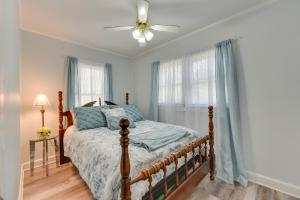 a bedroom with a bed and a ceiling fan at Rock Hill Cottage with Spacious Yard and Fire Pit! in Rock Hill