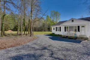 a white house with a porch and a driveway at Rock Hill Cottage with Spacious Yard and Fire Pit! in Rock Hill