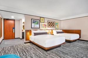 a hotel room with two beds and a hallway at Hotel Indigo - Minneapolis Downtown by IHG in Minneapolis +237 photos