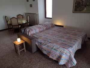 a bedroom with a bed and a table with a candle on it at Appartamento Teoperga in Sotto il Monte