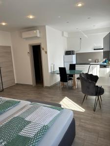 een kamer met een bed, een tafel en een keuken bij Apartment Im Sand in Bad Schonborn