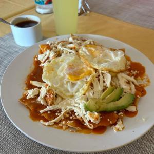 a plate of food on a table with a plate of food at Hotel Makarios in Tuxtla Gutiérrez