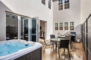 a bath tub with a table and chairs in a room at The Hudson #F2 townhouse in Hurricane