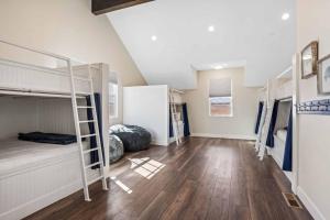 a room with bunk beds and wooden floors at The Hudson #F2 townhouse in Hurricane