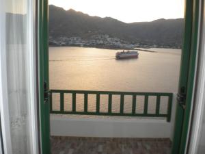 a view of a boat in the water from a window at Astrio Suites in Livadi