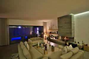 a large living room with couches and a fireplace at Moon house in Ville Nouvelle