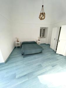 een witte kamer met een bed en twee tafels bij Agenzia Isotur GIACINTO in Ponza
