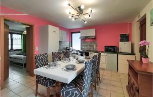 cocina y comedor con mesa blanca y sillas en Nice Home In Somme-leuze With Wifi, en Somme-Leuze