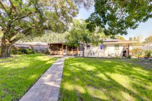 a yard with a pathway in front of a house at Charming Home with Yard about 5 Mi to Clearwater Beach! in Clearwater