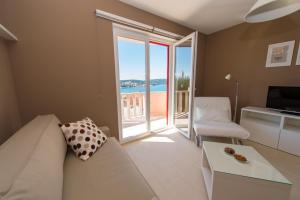 a living room with a couch and a view of the ocean at Apartments Gazebo in Trogir