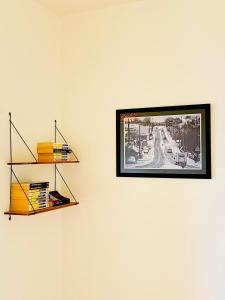 a picture hanging on a wall with a shelf at Guethary superbe appartement centre proche plage in Guéthary