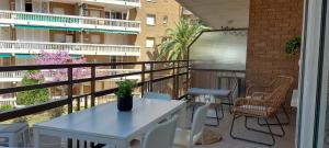 a patio with a white table and chairs on a balcony at Colibri Apartment Beach in Salou
