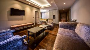 a living room with two couches and a tv at Prestige Hotel Budapest in Budapest