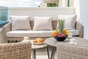 a couch and a table with fruit on a balcony at Villa Ivo in Promajna