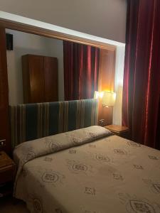 a bedroom with a bed with a headboard and curtains at Terminal guest house 24 in Rome