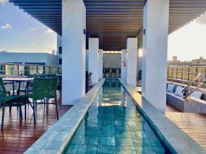 a swimming pool on the roof of a building at ARPOAR - Manaíra by PenareiaTurBr in João Pessoa
