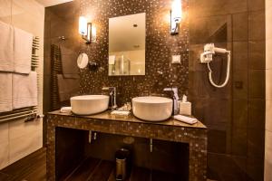 a bathroom with a sink and a mirror at Prestige Hotel Budapest in Budapest