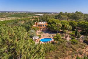 an aerial view of a villa with a swimming pool at Meia Lua - Deluxe countryside villa with pool and sea views near Barril beach, Tavira in Luz de Tavira