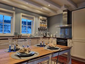 a kitchen with a table with food on it at Sjøhus ved Tjeldsundet - House by the sea in Evenskjer