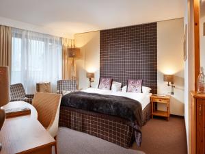 A bed or beds in a room at Das Alpenhaus Kaprun inkl Zell am See-Kaprun Sommerkarte