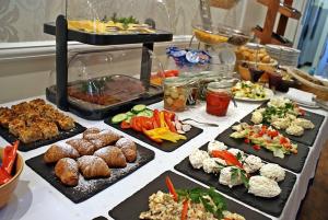 a buffet with many different types of food on a table at Villa Antonina in Sopot