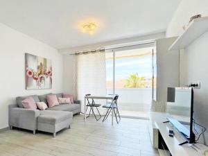 a living room with a couch and a table at Playa Honda Apartamento Abeja in Playa de las Americas