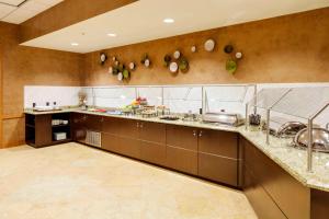 a large kitchen with stainless steel cabinets and counters at Courtyard by Marriott Boston Logan Airport in Boston