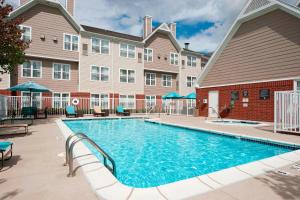a swimming pool in front of a building at Residence Inn by Marriott Grand Rapids West in Grand Rapids