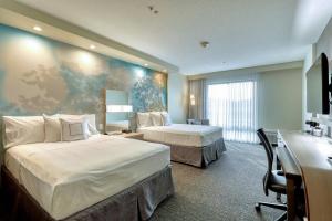 a hotel room with two beds and a desk at Courtyard by Marriott Southington in Southington