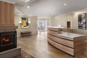 a living room with a fireplace and a counter at Residence Inn El Paso in El Paso