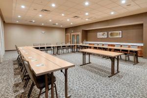 a conference room with wooden tables and chairs at Courtyard by Marriott Southington in Southington