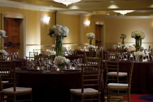a banquet hall with tables with chairs and flowers at Renaissance New Orleans Arts Warehouse District Hotel in New Orleans +42 photos