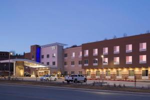 a building with two cars parked in front of it at Fairfield Inn & Suites by Marriott Durango in Durango