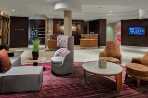 a lobby with chairs and tables in a hotel at Courtyard Flagstaff in Flagstaff