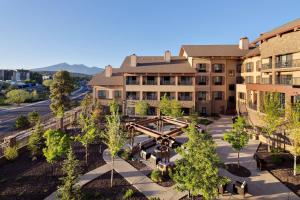 an aerial view of a building with trees in front at Courtyard Flagstaff in Flagstaff