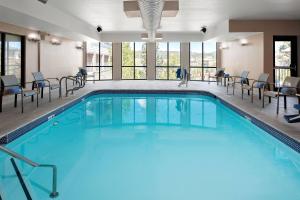 a large swimming pool with chairs and tables at Courtyard Flagstaff in Flagstaff