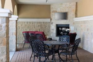 a patio with a table and chairs and a fireplace at TownePlace Suites Fort Worth Downtown in Fort Worth