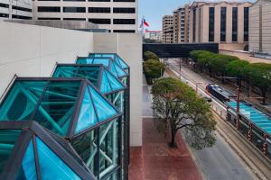 two views of a building in a city at Houston Marriott Medical Center/Museum District in Houston