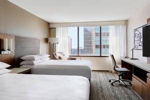 a hotel room with two beds and a large window at Houston Marriott Medical Center/Museum District in Houston