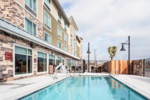 a swimming pool in front of a building at TownePlace Suites by Marriott Austin Parmer/Tech Ridge in Austin
