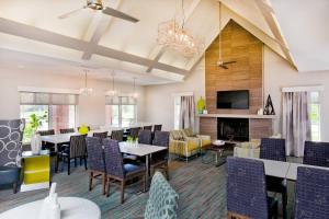 a dining room with tables and chairs and a fireplace at Residence Inn by Marriott Hanover Lebanon in Lebanon