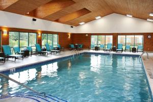 a large swimming pool with chairs and tables at Residence Inn by Marriott Ann Arbor North in Ann Arbor