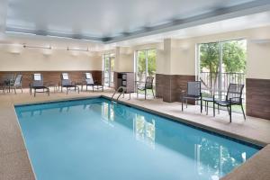 uma grande piscina com cadeiras e mesas em Fairfield Inn & Suites by Marriott Athens-University Area em Athens
