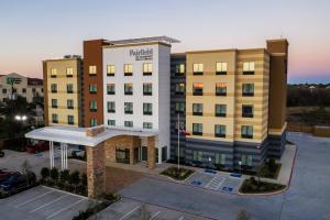 an aerial view of a hotel building with a parking lot at Fairfield Inn and Suites by Marriott Houston Brookhollow in Houston