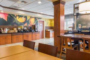 a restaurant with wooden tables and a kitchen at Fairfield Inn & Suites Columbia in Columbia