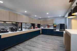 a large kitchen with blue counters and appliances at TownePlace Suites by Marriott Baton Rouge South in Baton Rouge