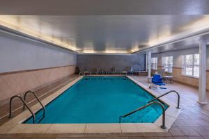 a swimming pool with blue water in a building at TownePlace Suites by Marriott Baton Rouge South in Baton Rouge