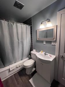 a bathroom with a white toilet and a sink at HWY 17 Hotel in Wawa +19 photos